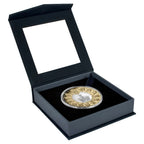 Decorative coin in a black display box on a white background