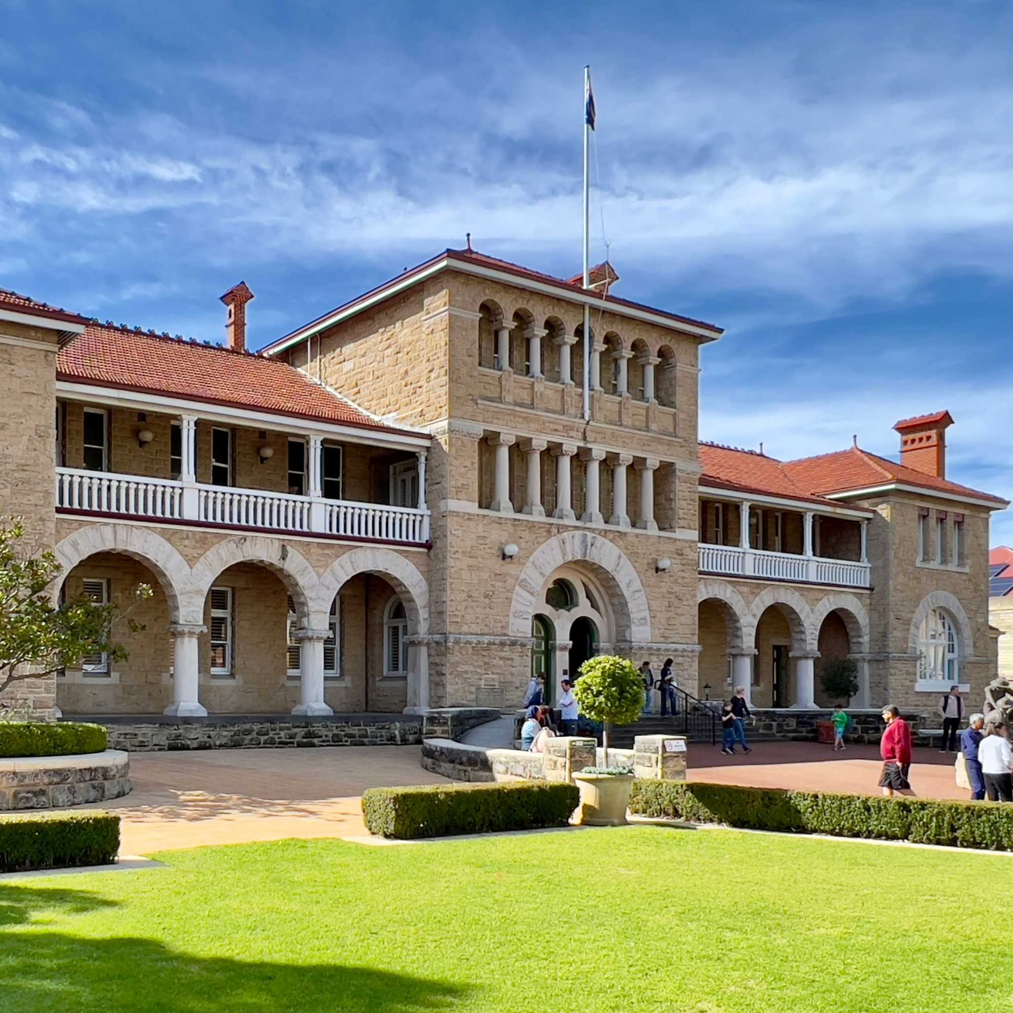 The Perth Mint, historic stone building with a flagpole against a blue sky