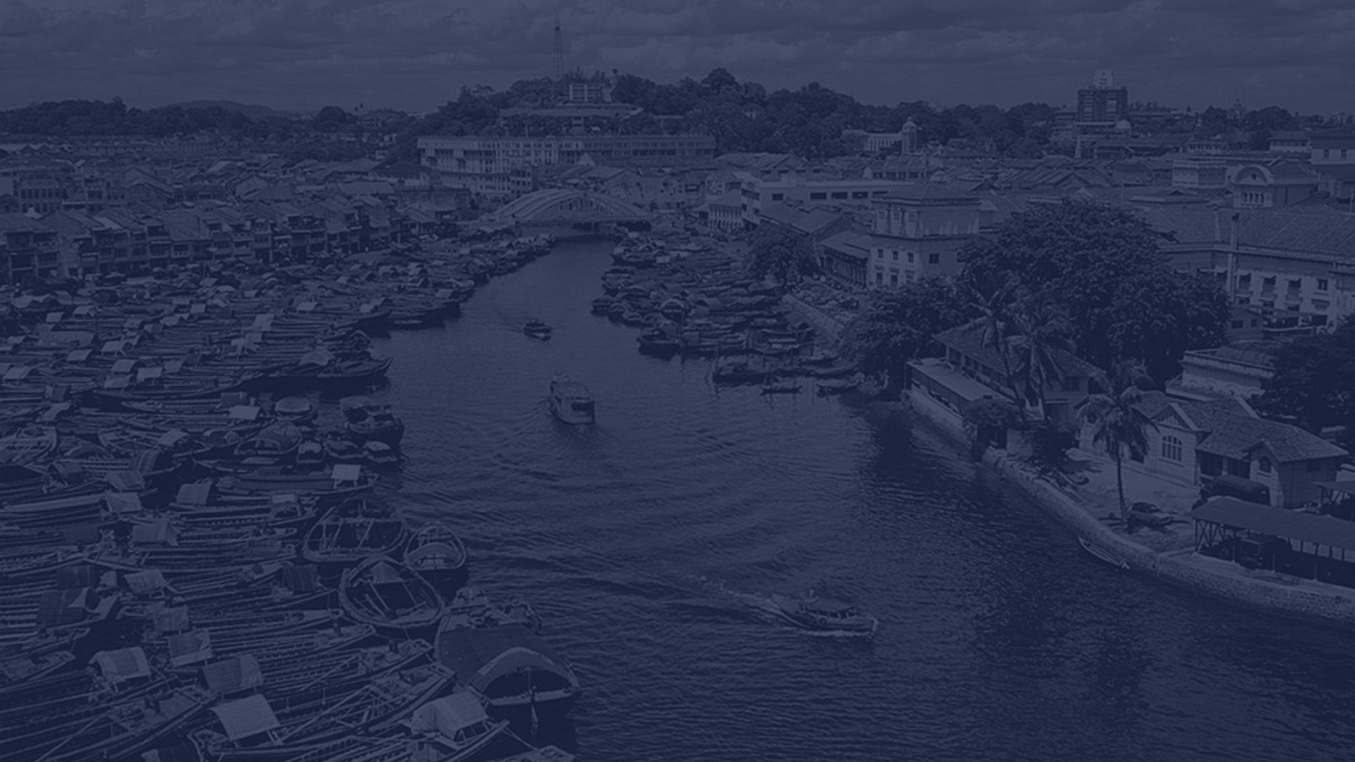 Heritage Straits Coins banner featuring a black-and-white photograph of Boat Quay along the Singapore River, depicting mid-20th-century riverfront buildings and boats in 1953.