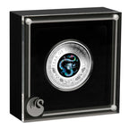 Silver coin with dragon design in a black display case