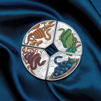 2025 snake quadrant silver proof coloured one ounce from the Perth Mint, four-part circular design with snake illustrations on a blue fabric background