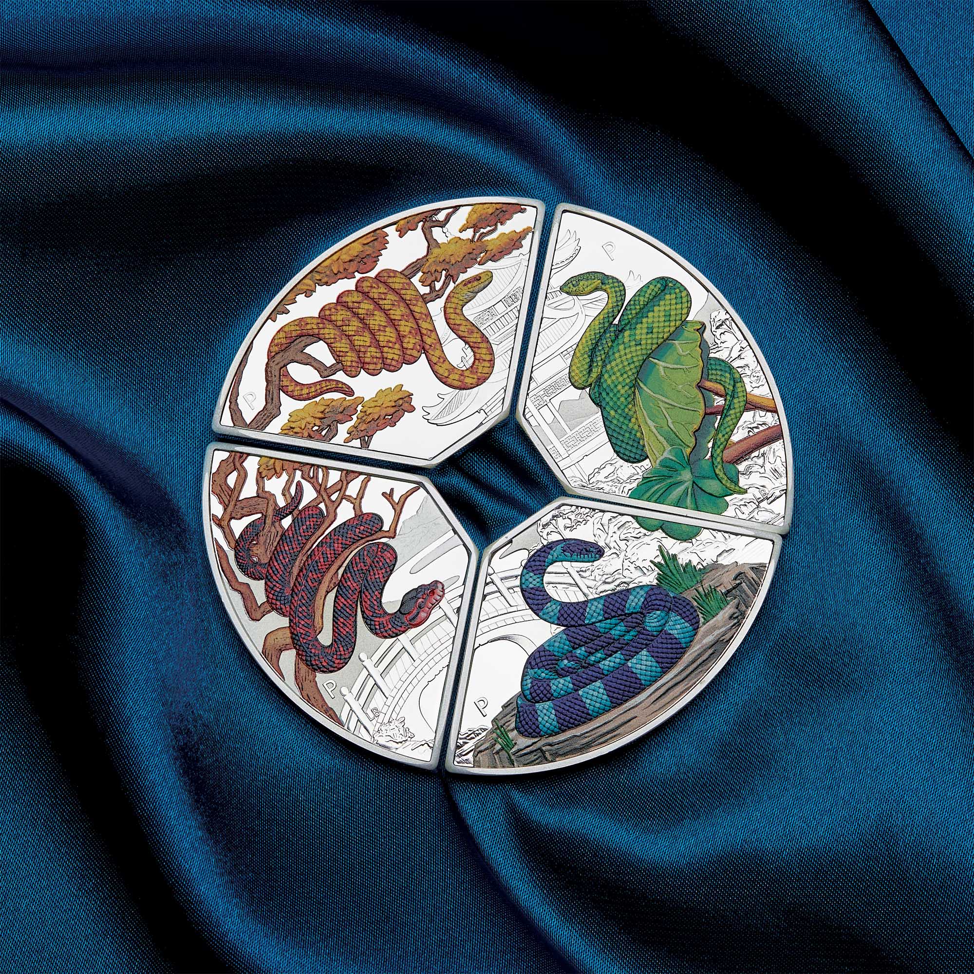 2025 snake quadrant silver proof coloured one ounce from the Perth Mint, four-part circular design with snake illustrations on a blue fabric background