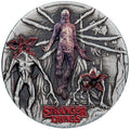 2026 Stranger Things The Villains two-ounce silver antiqued coin from The Perth Mint, with a central figure of Vecna and two demogorgans on a white background