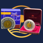 Royal Australian Mint 2002 Adelaide Pound gold and silver coin in a red case with packaging in the background