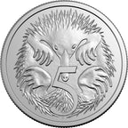 Silver coin with a design of a platypus and the number 5 on a white background