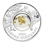 Royal Australian Mint 2004 Eureka Stockade silver coin with gold pieces and engraved figures on a white background