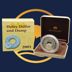 Royal Australian Mint 2003 Holey Dollar and Dump coin with packaging on a blue background