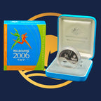 Royal Australian Mint 2006 Queen's Baton silver coin in a blue case with a Melbourne 2006 Commonwealth Games box on a dark blue background
